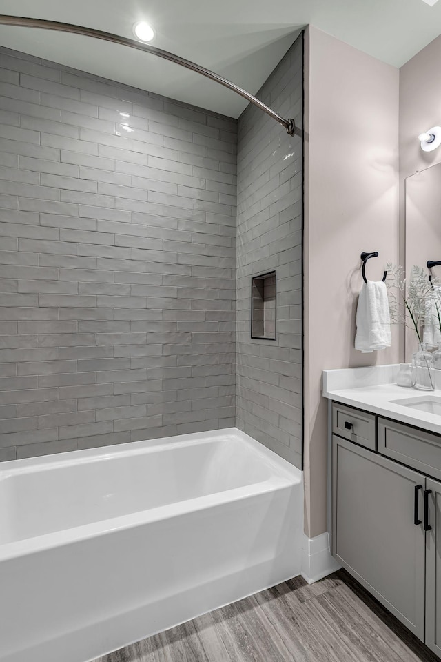 bathroom with vanity and tiled shower / bath