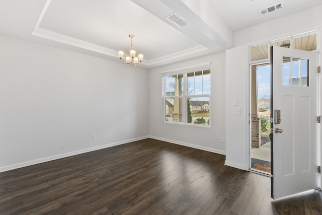 entrance foyer with a tray ceiling, an inviting chandelier, and dark hardwood / wood-style floors