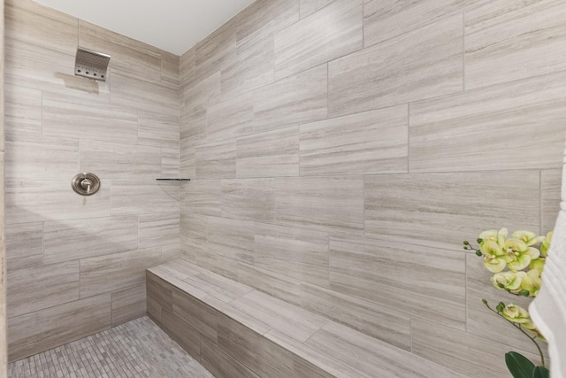 bathroom with tiled shower