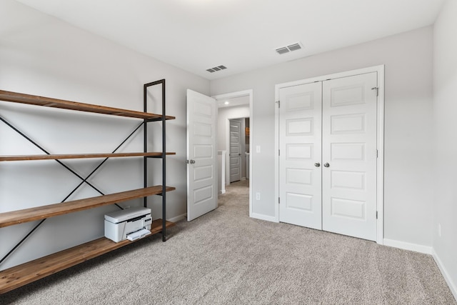 unfurnished bedroom with carpet and a closet