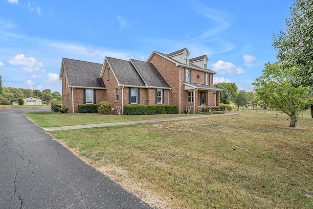 view of front of home with brick siding and a front lawn