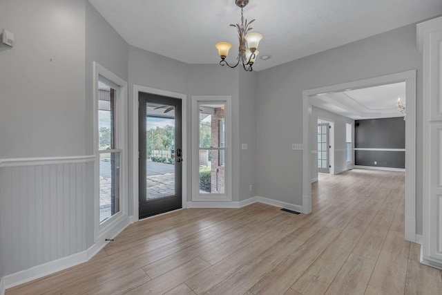 foyer featuring a chandelier and light hardwood / wood-style flooring