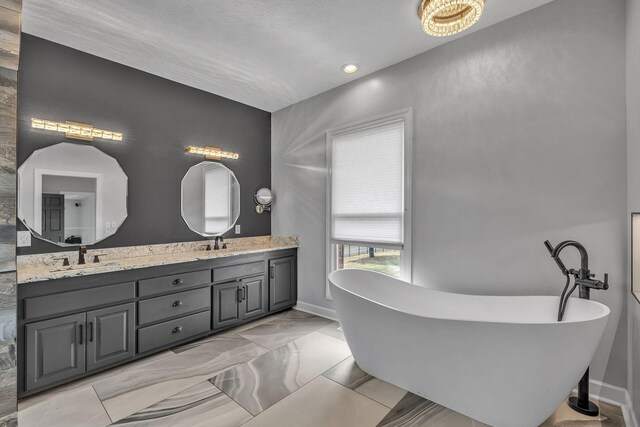 bathroom with a tub and vanity