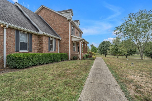 view of side of property featuring a yard