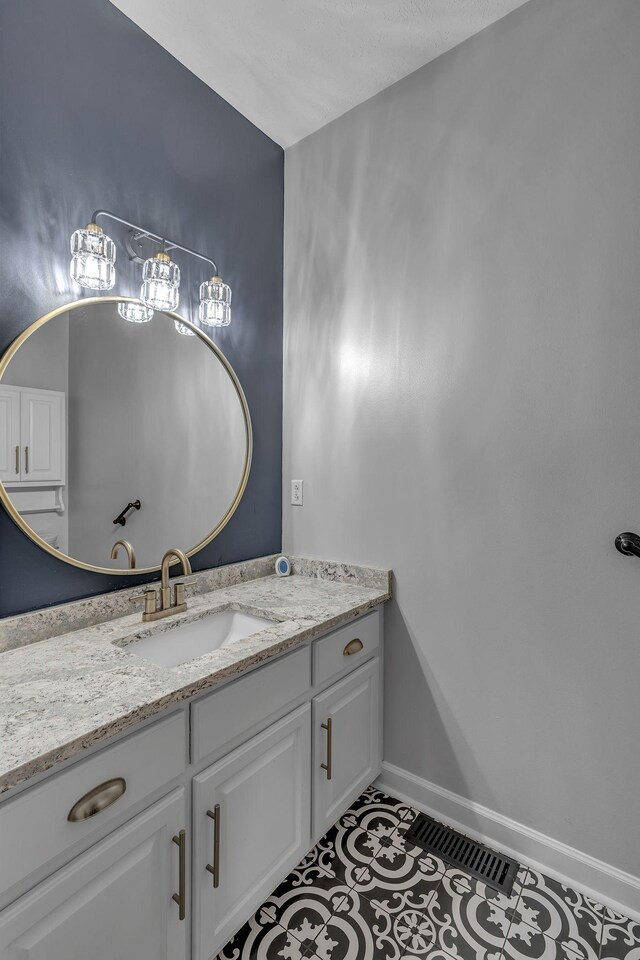 bathroom featuring tile patterned flooring and vanity