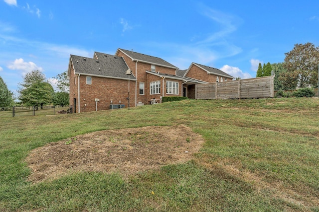 back of house featuring a yard