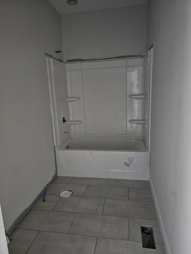 bathroom featuring tile patterned flooring and washtub / shower combination