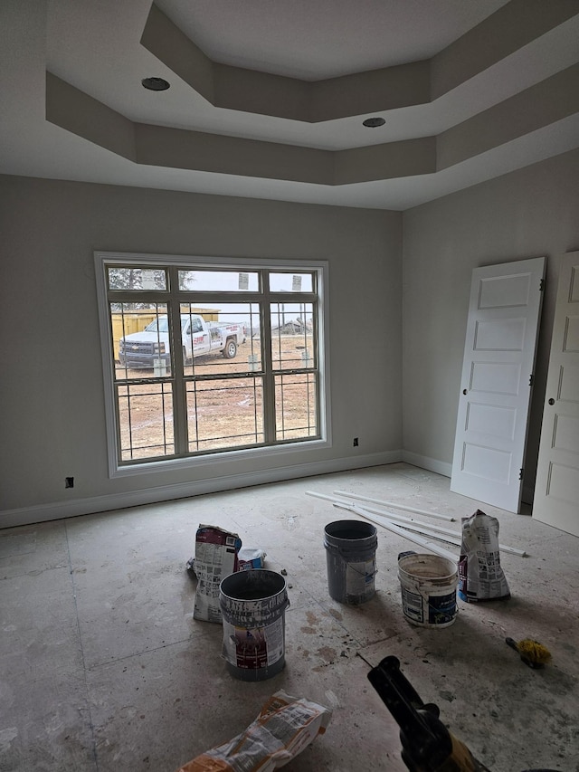 empty room featuring a raised ceiling