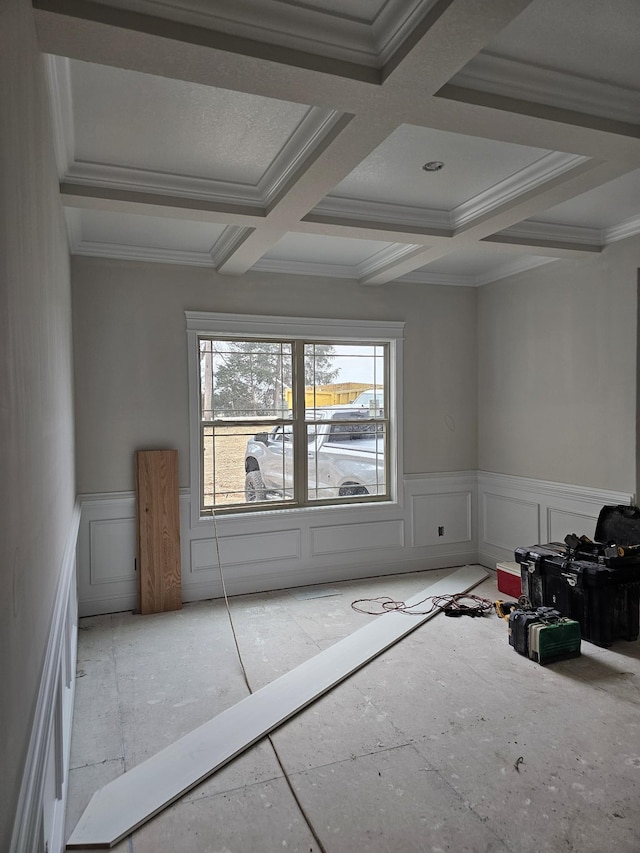 empty room featuring beam ceiling, crown molding, and coffered ceiling