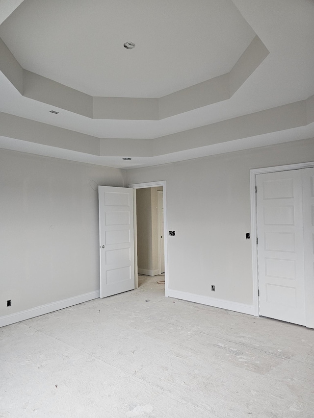 spare room with a raised ceiling