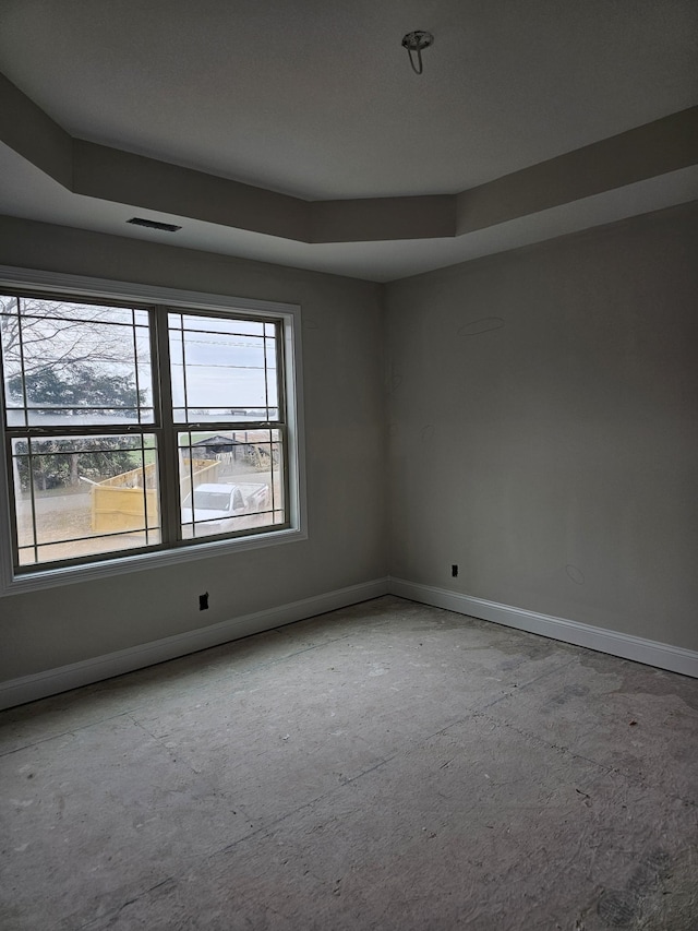 unfurnished room with a tray ceiling