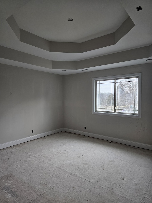 spare room featuring a raised ceiling