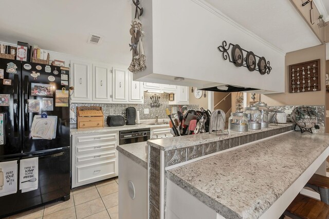 kitchen with a kitchen bar, kitchen peninsula, white cabinetry, and black appliances