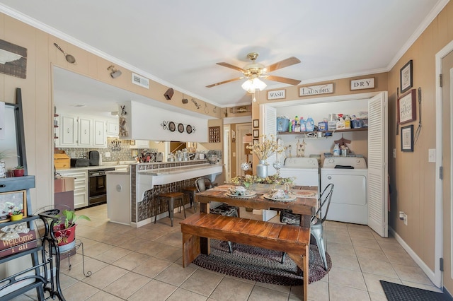 dining area with washer and dryer, ceiling fan, ornamental molding, and light tile patterned floors