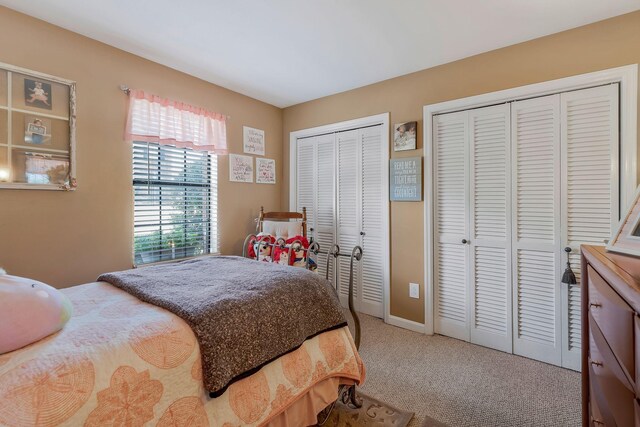 carpeted bedroom with multiple closets