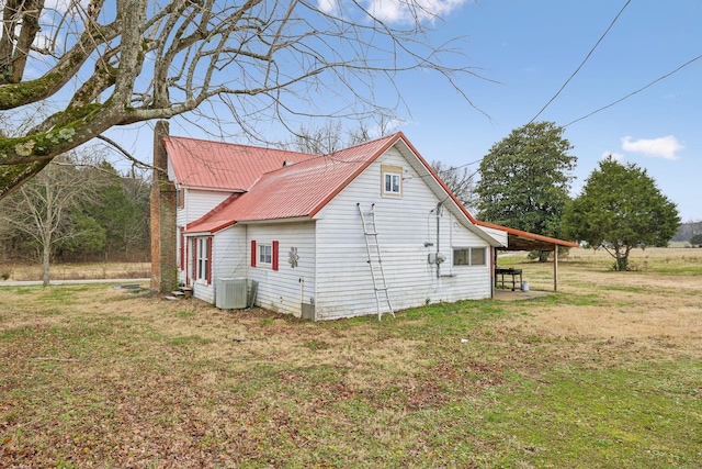 view of home's exterior with a lawn and cooling unit