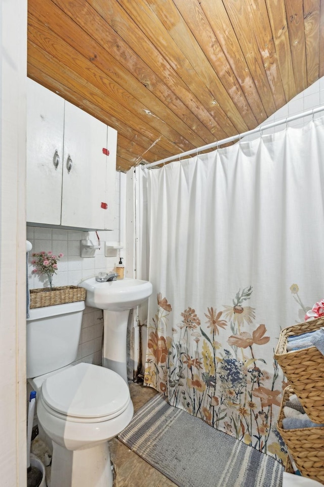 bathroom featuring vaulted ceiling, toilet, tile walls, and wood ceiling