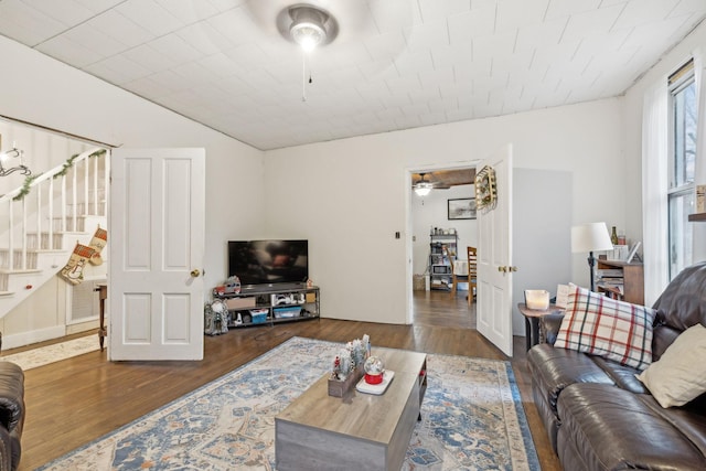 living room with dark hardwood / wood-style floors and ceiling fan