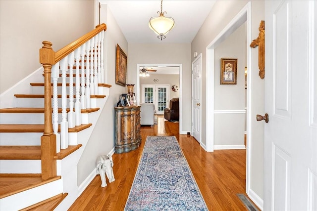 foyer featuring hardwood / wood-style floors, french doors, and ceiling fan