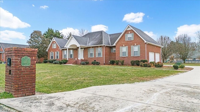 view of front of home featuring a front yard and a garage