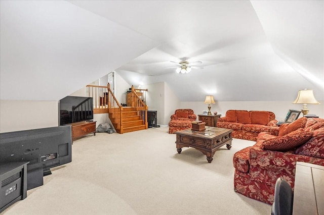 interior space with carpet, vaulted ceiling, and ceiling fan