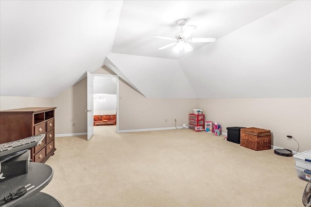 recreation room featuring ceiling fan, light carpet, and vaulted ceiling