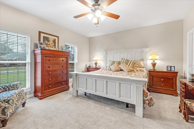 bedroom with ceiling fan and light colored carpet