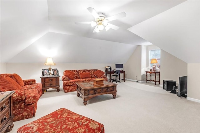 carpeted living room with ceiling fan and vaulted ceiling