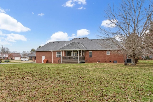 rear view of property with a yard