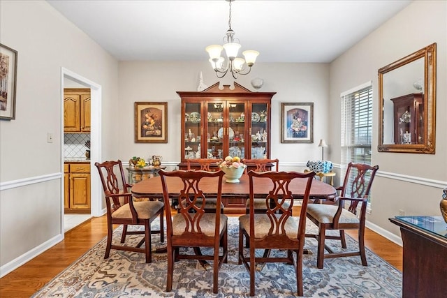 dining room featuring hardwood / wood-style floors and an inviting chandelier