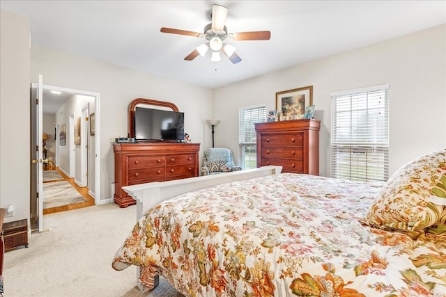 bedroom featuring ceiling fan and light carpet