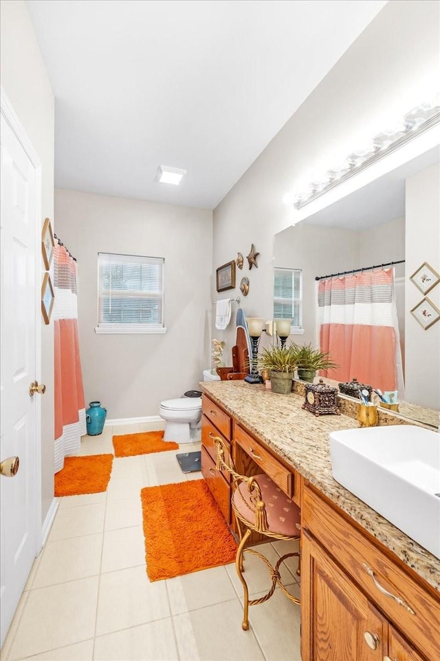 bathroom featuring tile patterned floors, vanity, and toilet