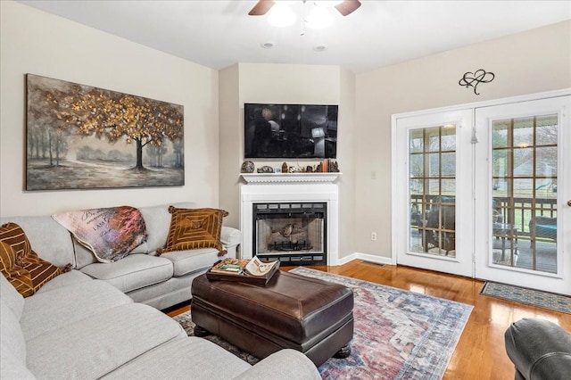 living room with ceiling fan and hardwood / wood-style floors