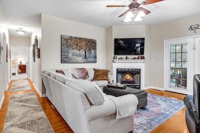 living room with hardwood / wood-style flooring and ceiling fan