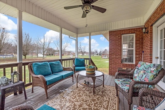 sunroom / solarium featuring ceiling fan and plenty of natural light