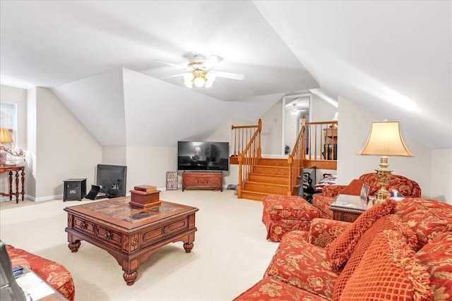 carpeted living room with ceiling fan and lofted ceiling