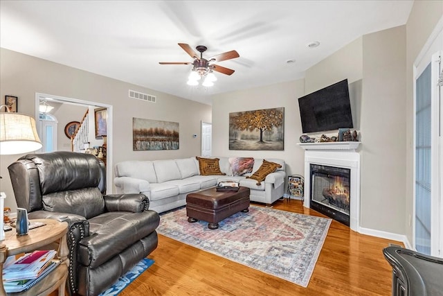 living room featuring hardwood / wood-style flooring and ceiling fan