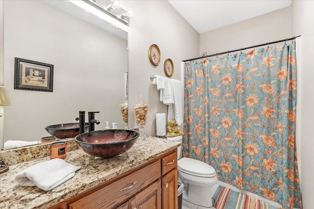 bathroom featuring tile patterned flooring, vanity, toilet, and a shower with shower curtain