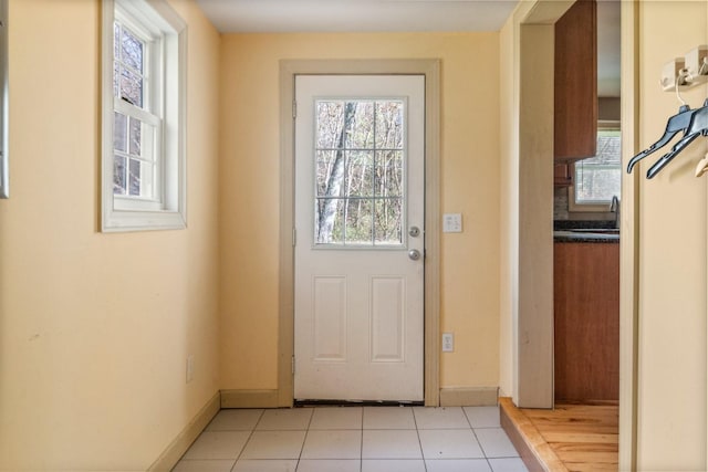 doorway featuring light tile patterned flooring