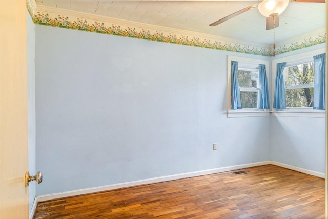 empty room featuring hardwood / wood-style flooring, ceiling fan, and crown molding