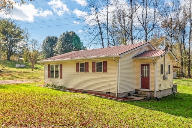 view of home's exterior featuring cooling unit and a yard