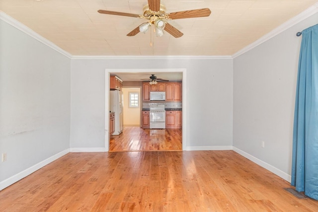 spare room featuring ceiling fan, light wood-type flooring, and crown molding