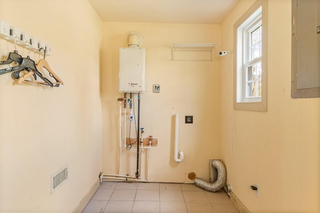 laundry area featuring electric dryer hookup, electric panel, water heater, and light tile patterned floors