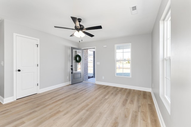 spare room featuring light wood-type flooring and ceiling fan