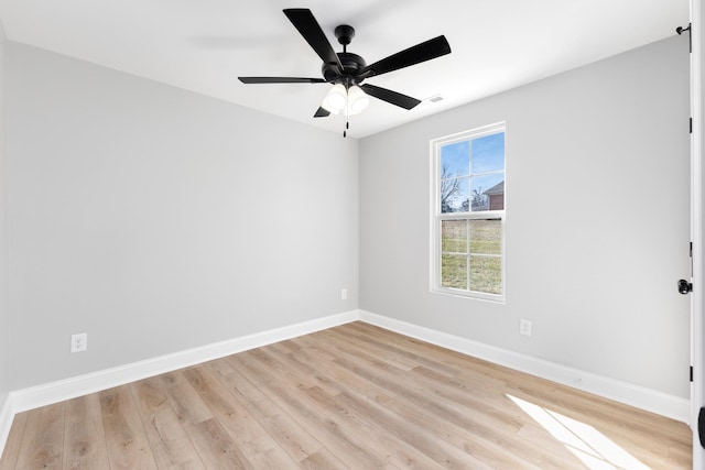 spare room with light wood-type flooring and ceiling fan