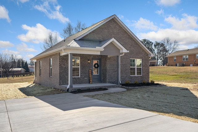 view of front of property with covered porch and a front lawn