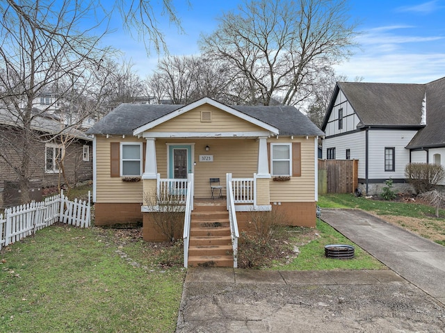 bungalow-style home featuring a porch and a front lawn