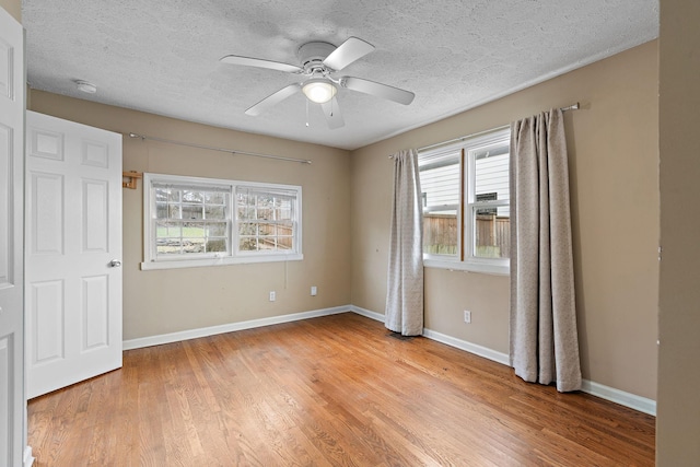 unfurnished bedroom with ceiling fan, light hardwood / wood-style floors, and a textured ceiling