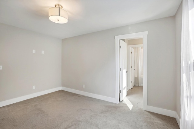 unfurnished room with light carpet