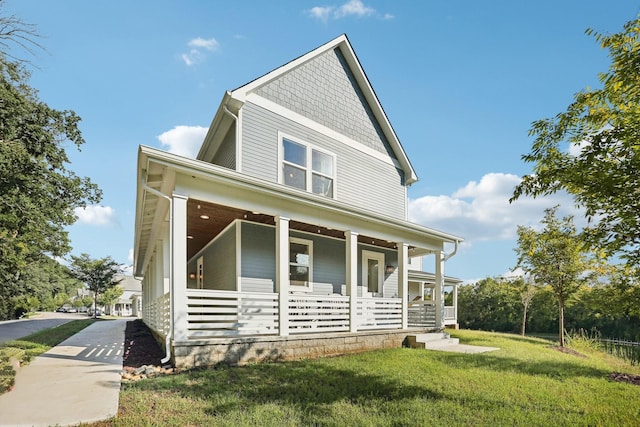 view of front of house featuring covered porch and a front yard